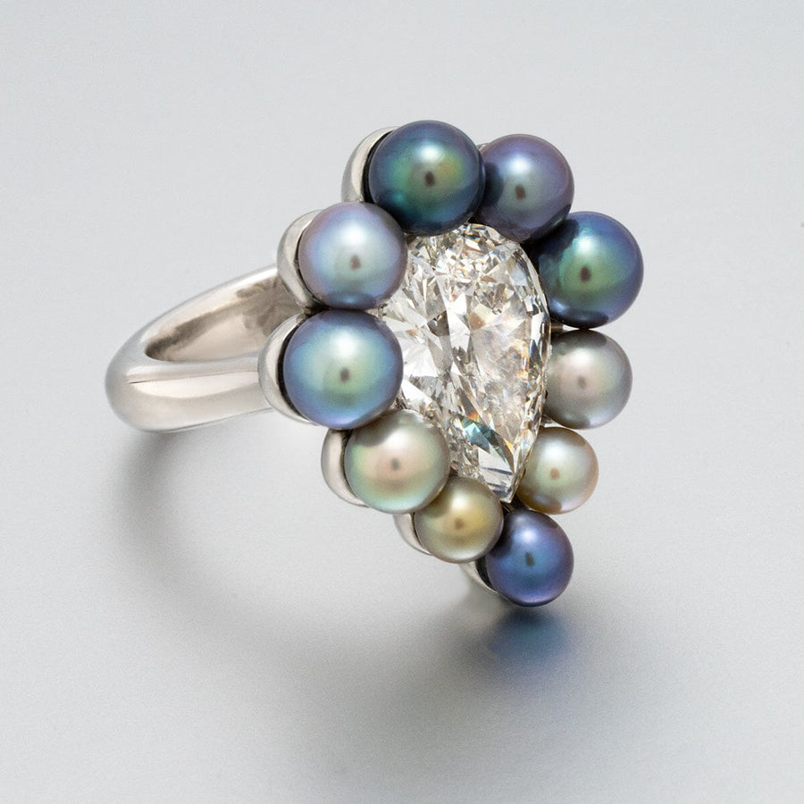 Assael Collection: 10.95 Carat Natural Pearl and 5.05 Carat Natural Diamond Platinum Ring featuring a pear-shaped diamond surrounded by a halo of multicolored natural pearls on a polished platinum band.