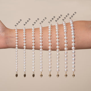Various sizes of 6.5-7.0 mm White Akoya AAA Pearl Bracelet strands displayed on a wrist for size comparison, showcasing cultured white pearls in graduated measurements.