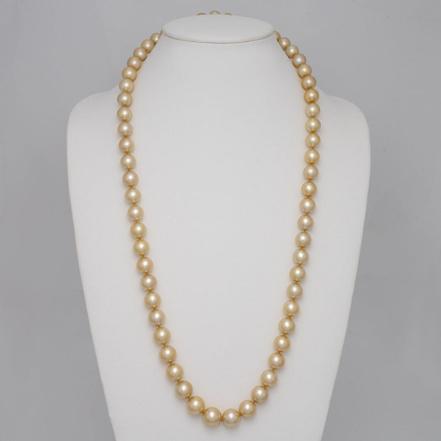 10.5–14.0 mm round golden South Sea endless pearl strand on bust
