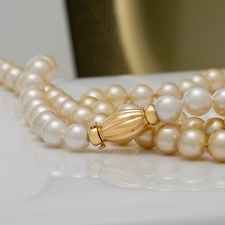 85 round white and golden South Sea pearls · 29.2 momme · approx. 35.25 inches · 18K yellow gold clasp