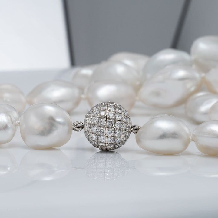 11.2–15.3 mm White South Sea keshi pearl necklace featuring 29 pearls and an 18K white gold diamond clasp with 106 diamonds totaling 2.39 carats.