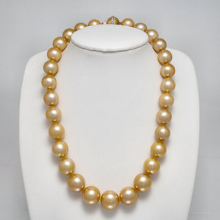13.0-15.9 mm AAA Round Golden South Sea Pearl Necklace on a dark background