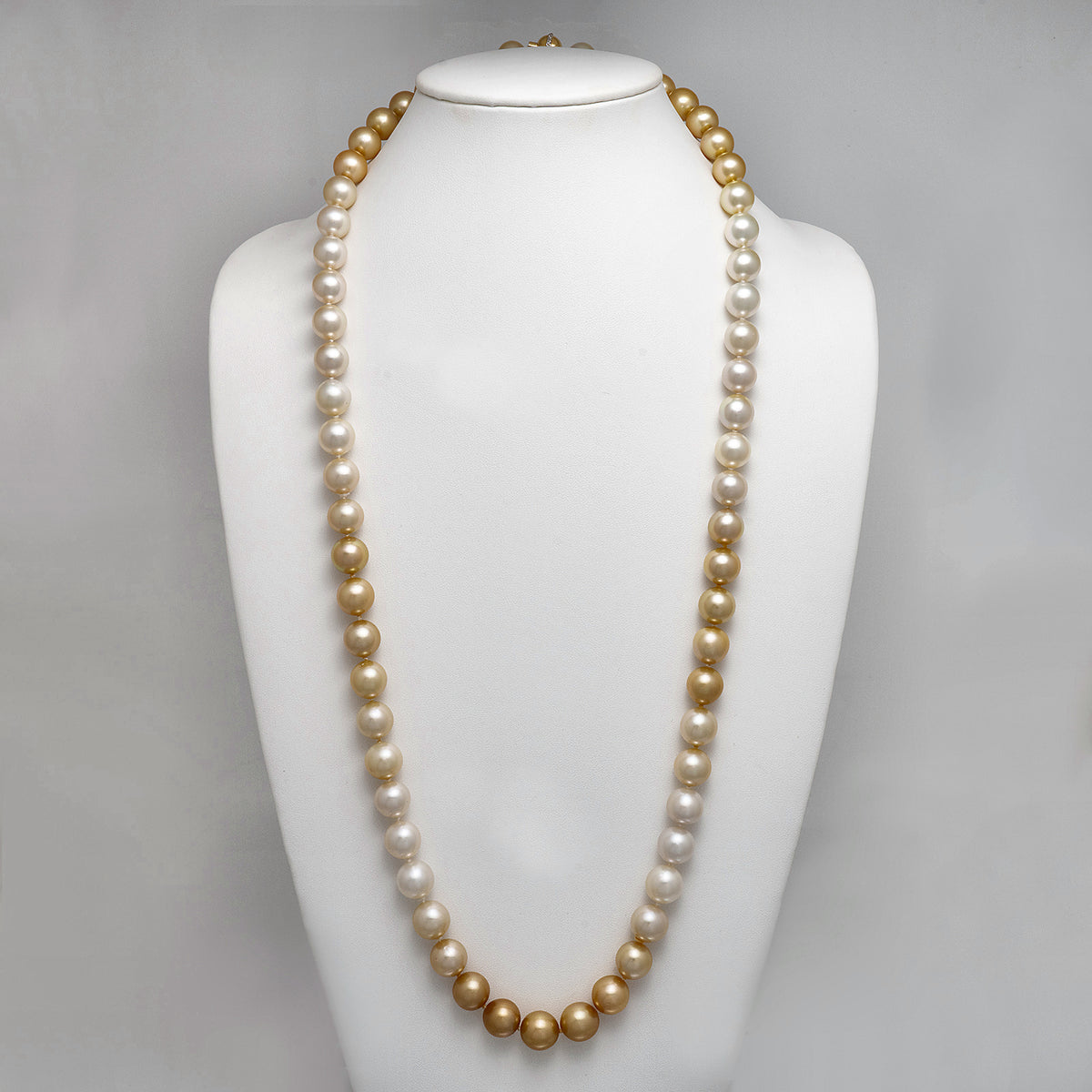 12.0-12.9 mm AAA Round Ombré White and Golden South Sea Pearl Rope Necklace on a dark background