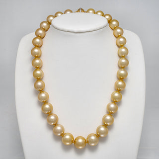 12.0-14.8 mm AAA Round Golden South Sea Pearl Necklace on a dark background