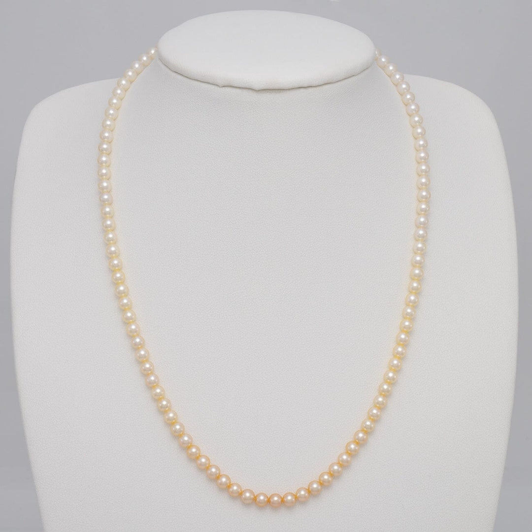 TF-22: 4-4.5 mm Natural-color Round Akoya Ombré Pearl Strand displayed on a white bust, showcasing a graceful gradient of natural-color akoya pearls in a classic strand necklace.