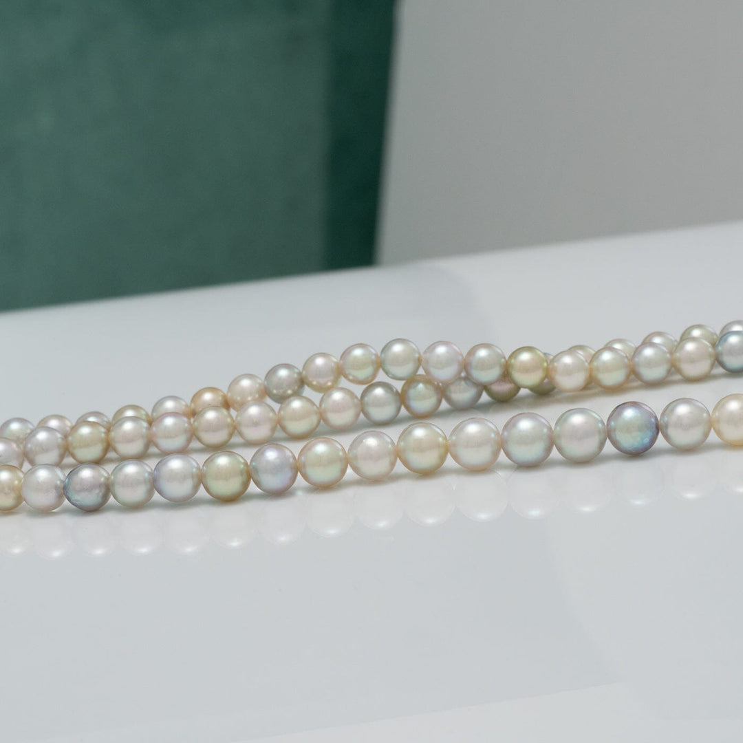 TF-25: 4-5 mm Natural Multicolor Akoya Pearl Round Strands featuring lustrous pearls in soft shades of white, pink, lavender, and subtle green tones arranged in elegant strands.