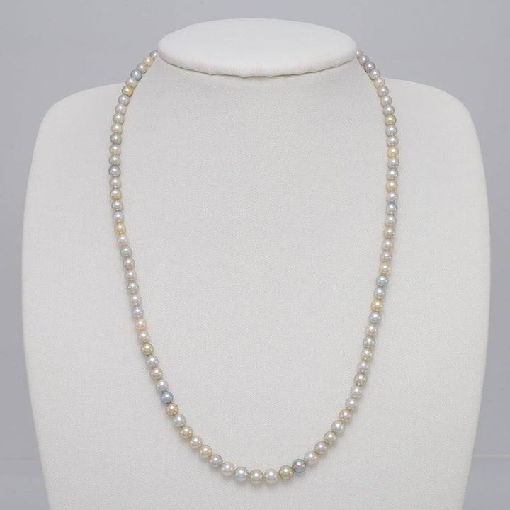 TF-25: 4-5 mm Natural Multicolor Akoya Pearl Round Strands necklace displayed on a white bust form, featuring lustrous round pearls in soft natural multicolor shades.