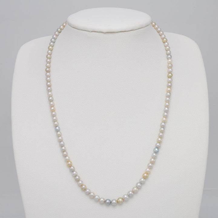 TF-26: 4-5 mm Natural Multicolor Akoya Pearl Round Strands necklace displayed on a white bust, featuring natural cultured pearls in soft white, gold, and blue hues.