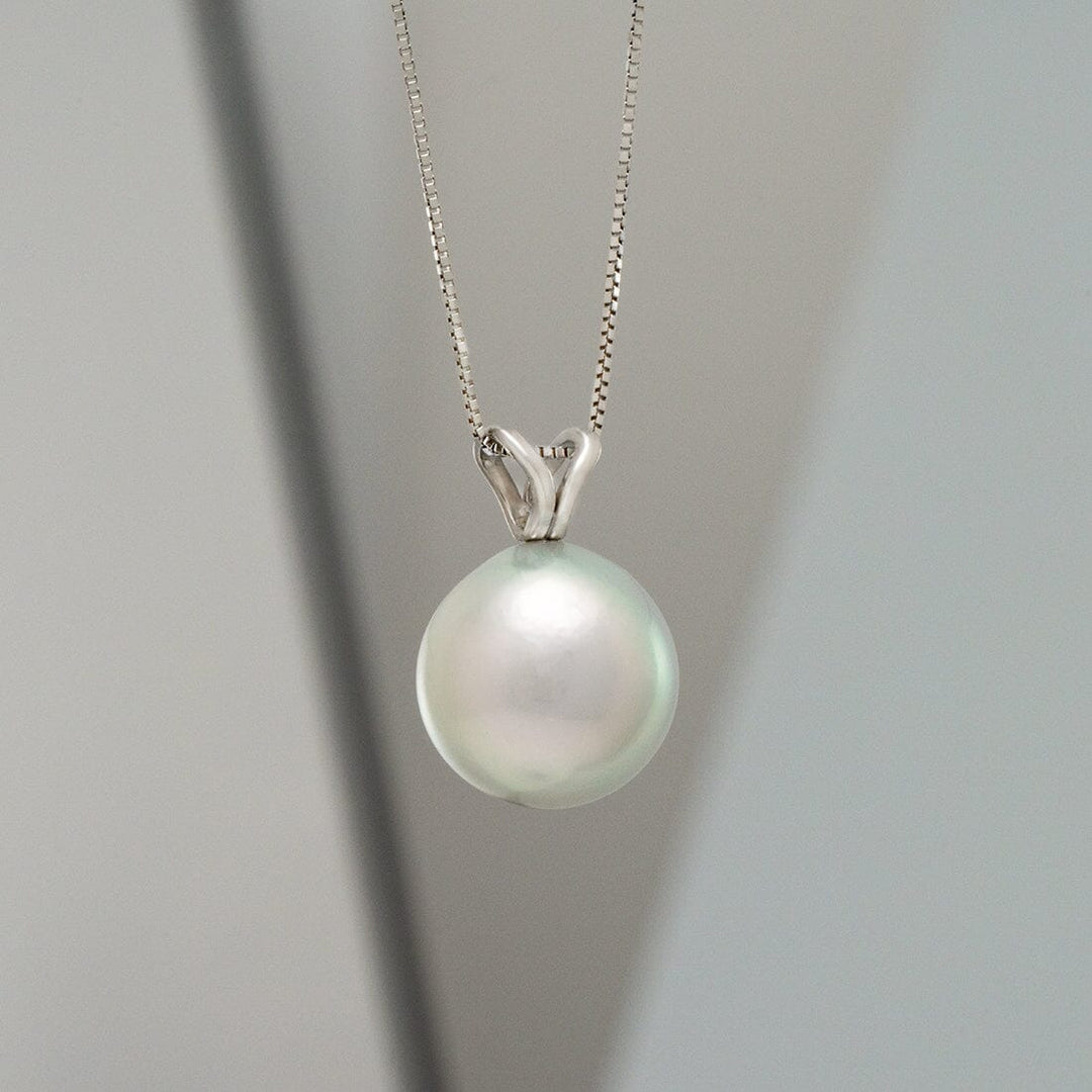 Elegant special color Akoya drop pearl pendant on a delicate silver chain, showcasing the TK4-B: 10-10.5 mm Special Color Akoya Drop Pearl Unity Pendant with a lustrous finish.