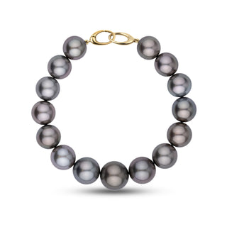 This bracelet features round AA+/AAA Tahitian pearls measuring 11.0–13.3 mm. The pearls display a dark gunmetal gray body color with smooth surfaces and sharp, reflective luster – yellow gold orbit clasp
