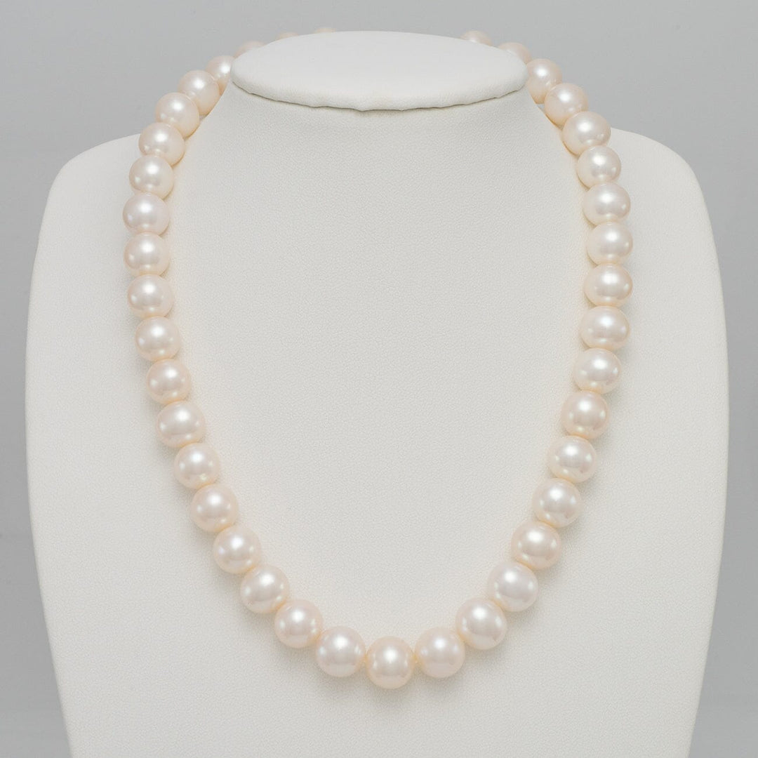 10.5-11.5 mm AA+ White Freshwater Pearl Necklace displayed on a white jewelry bust, featuring lustrous round white pearls with a smooth surface and elegant shine.