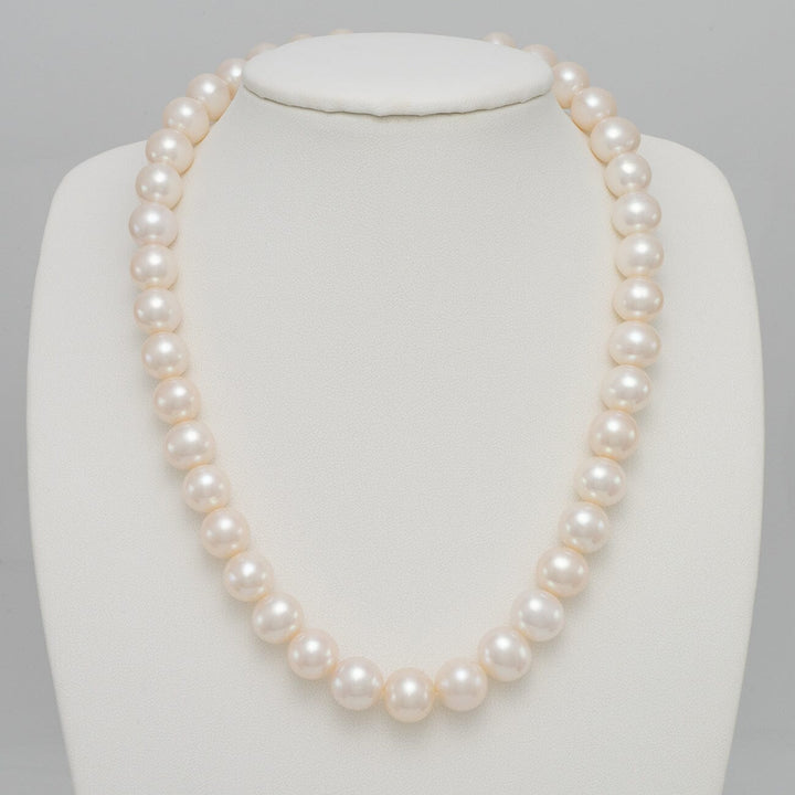 10.5-11.5 mm AA+ White Freshwater Pearl Necklace displayed on a white jewelry bust, featuring lustrous round white pearls with a smooth surface and elegant shine.