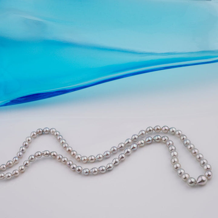 B-12: 3-4.5 mm Silver-blue Drop Akoya Strands, 16-inch Unfinished Strand displayed elegantly with lustrous, round cultured akoya pearls in silver-blue hues.