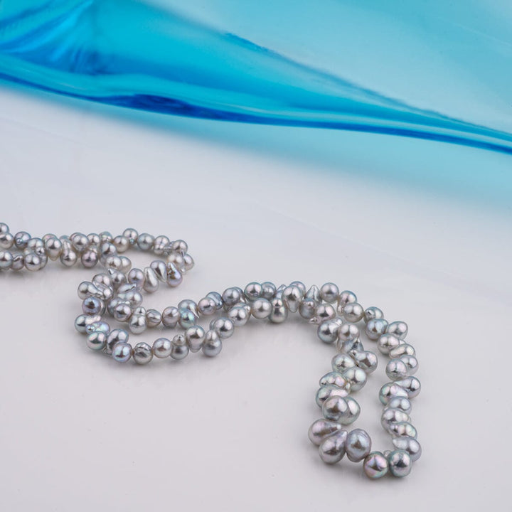 B-16: 2.5-4 mm Top-drilled Blue Baroque Akoya Strands, 18-inch Unfinished Strand featuring lustrous irregular blue pearls ideal for creating unique pearl necklaces and fine jewelry designs.