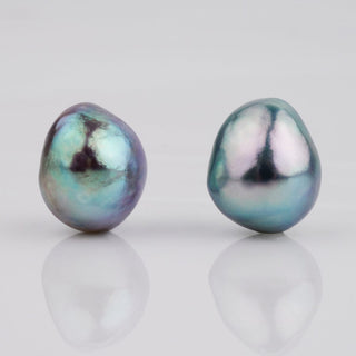 B-9: 9.0-9.5 mm Baroque Blue Akoya Pearl Pairs displaying lustrous, irregular shapes with a unique blue and green iridescent sheen on smooth surfaces.