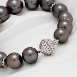Assael Collection: 10.9–13.1 mm Tahitian Pearl and Diamond Bracelet featuring lustrous dark Tahitian pearls with a sparkling diamond-encrusted clasp on a white background.