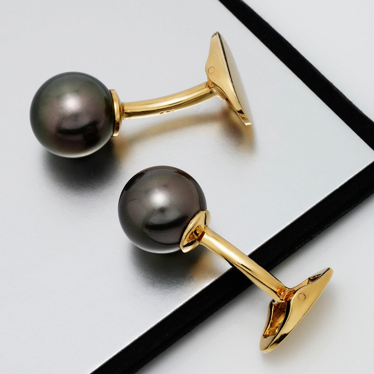 Assael Collection: 11.0 mm Tahitian Pearl Cufflinks featuring lustrous black pearls set on polished gold tone metal with a sleek and elegant design.