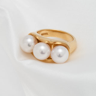 Assael Collection: 8.0–8.5 mm Akoya Three-Pearl Ring with three lustrous white akoya pearls set in a polished gold band, displayed on soft white fabric.