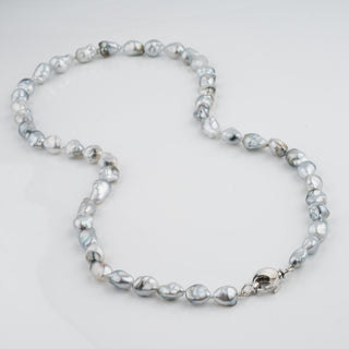 Assael Collection: 9.9–13.0 mm Fijian Pearl Keshi Necklace featuring irregular grayish-white pearls with a smooth 14K white gold clasp on a white background.