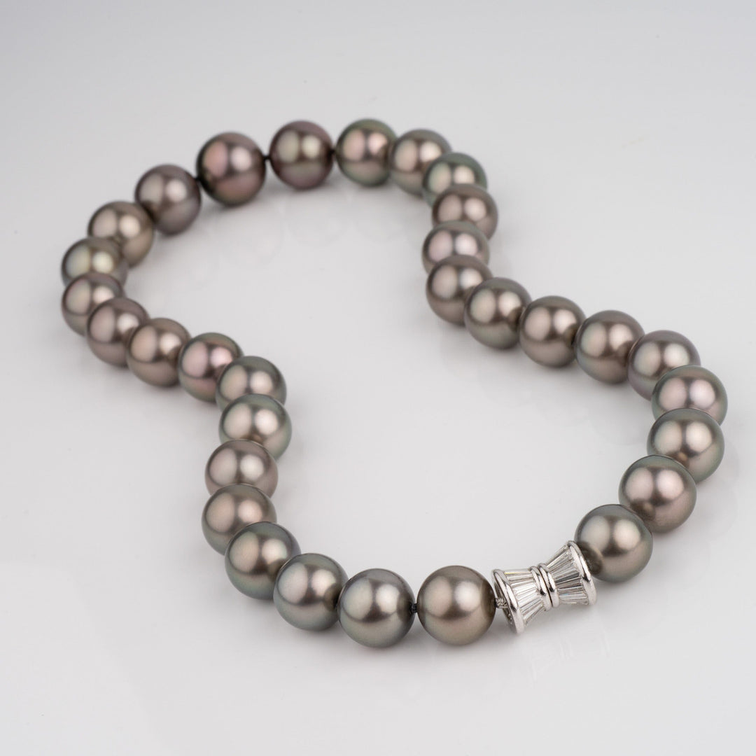 Gem grade Tahitian necklace with medium dark green bodycolor and rich purple peacock overtones. Round 11.6–15.0 mm pearls, natural color, finished with a 2.47 ct diamond clasp.