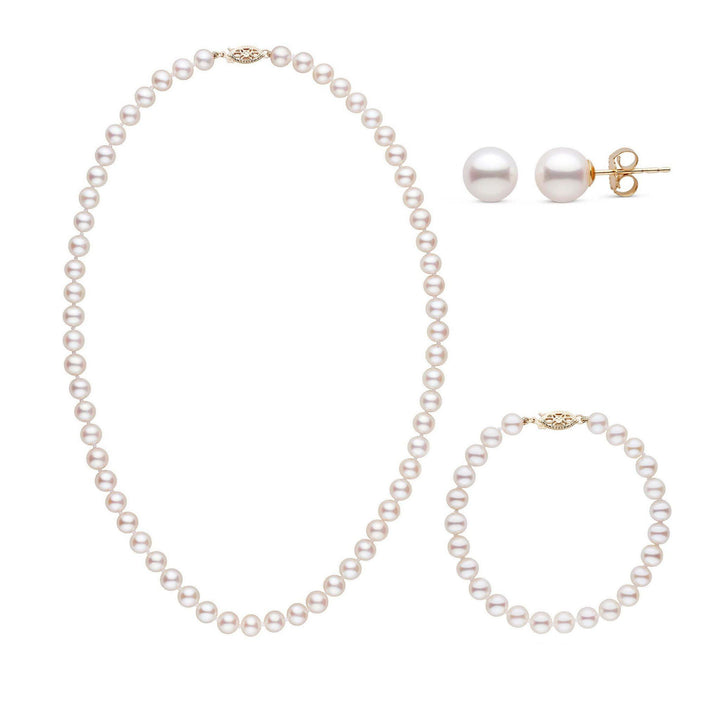 A three-piece set of white freshwater pearls including a necklace, a bracelet, and a pair of stud earrings, set in 14k yellow gold all displayed on a white background.