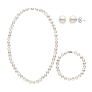 A three-piece set of white freshwater pearls including a necklace, a bracelet, and a pair of stud earrings, with each piece knotted and clasped in white gold.
