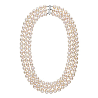 A triple-strand necklace of white freshwater cultured pearls with a gold clasp.