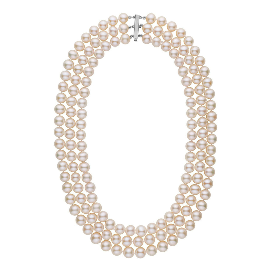 A triple-strand necklace of white freshwater cultured pearls with a gold clasp.