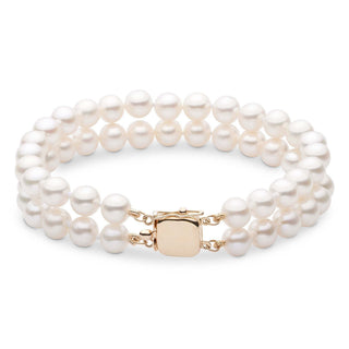 A double strand bracelet of white freshwater pearls with a yellow gold clasp