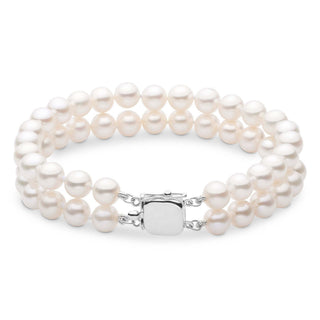 A double strand bracelet of white freshwater pearls with a gold clasp