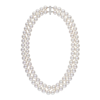 A double strand of white freshwater pearls with a gold clasp, knotted and displayed against a white background.