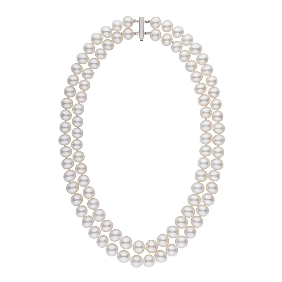 A double strand of white freshwater pearls with a gold clasp, knotted and displayed against a white background.