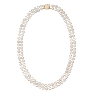 A double strand of white akoya pearls with a gold clasp, displayed against a white background.