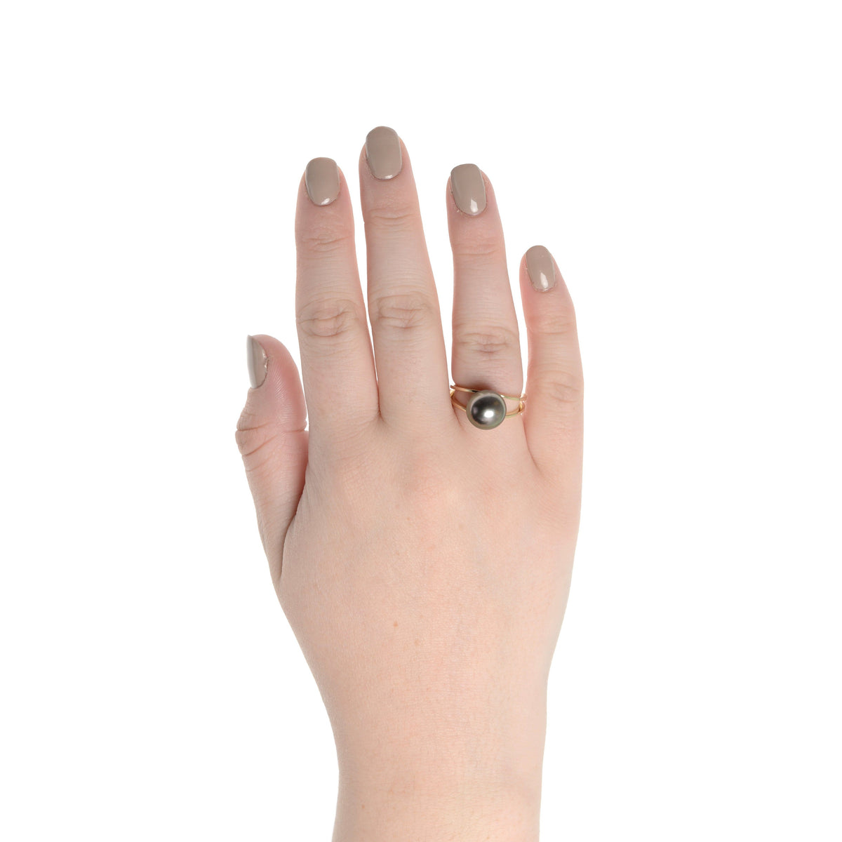 Hand wearing the Bridge Collection 10.0-11.0 mm Tahitian Pearl Ring featuring a single dark Tahitian pearl set on a gold band against a white background.