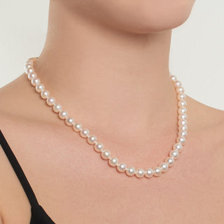 model wearing 18 inch strand of 7.5-8.0 mm white freshadama pearls
