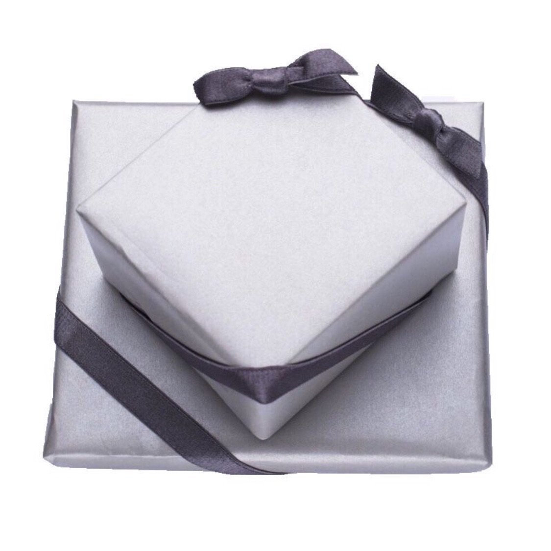 Two elegantly gift-wrapped boxes in silver paper with dark gray ribbons and bows, showcasing sophisticated gift-wrapping for special occasions.