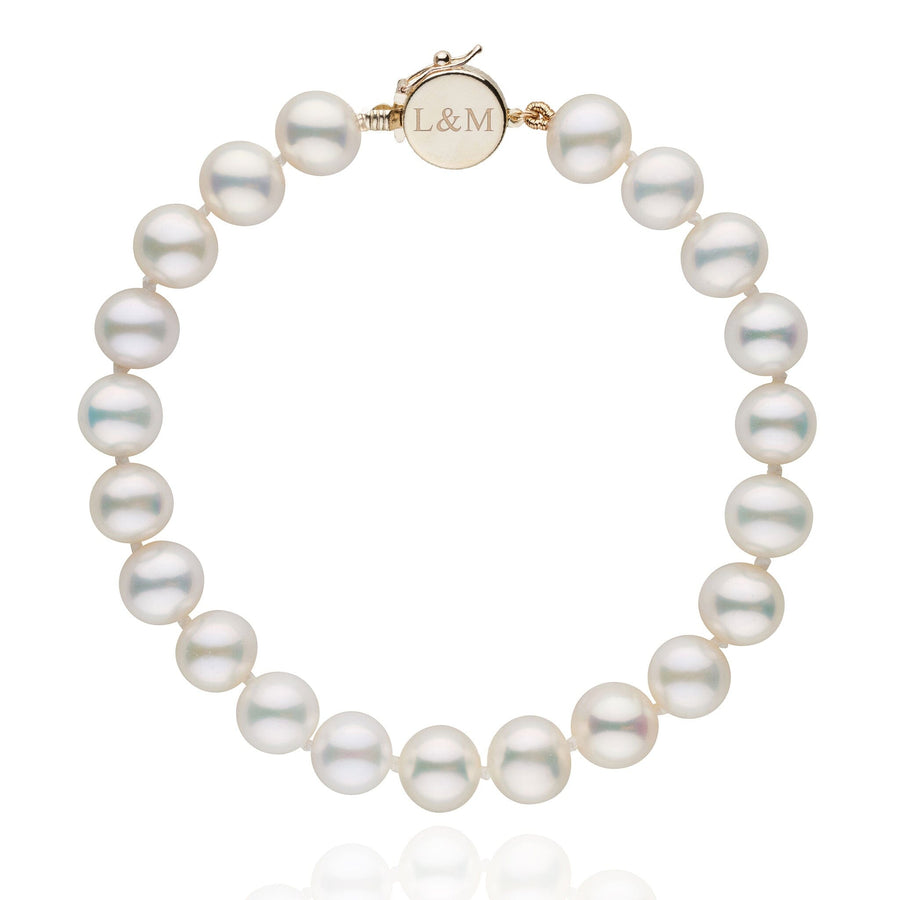 Personalized 7.5-8.0 mm AAA White Freshwater Pearl Circle Clasp Bracelet featuring lustrous white pearls and a polished gold circle clasp engraved with initials L&M