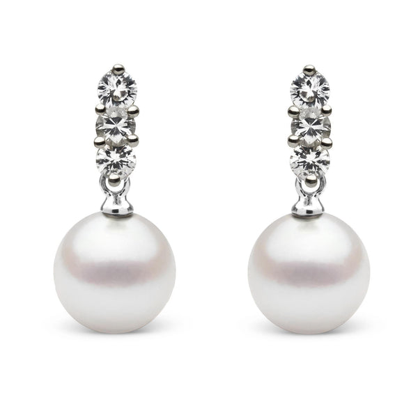 Pair of elegant Trio Collection 8.5-9.0 mm Akoya Pearl and Diamond Earrings featuring round white cultured pearls suspended from three sparkling diamonds in a classic setting.