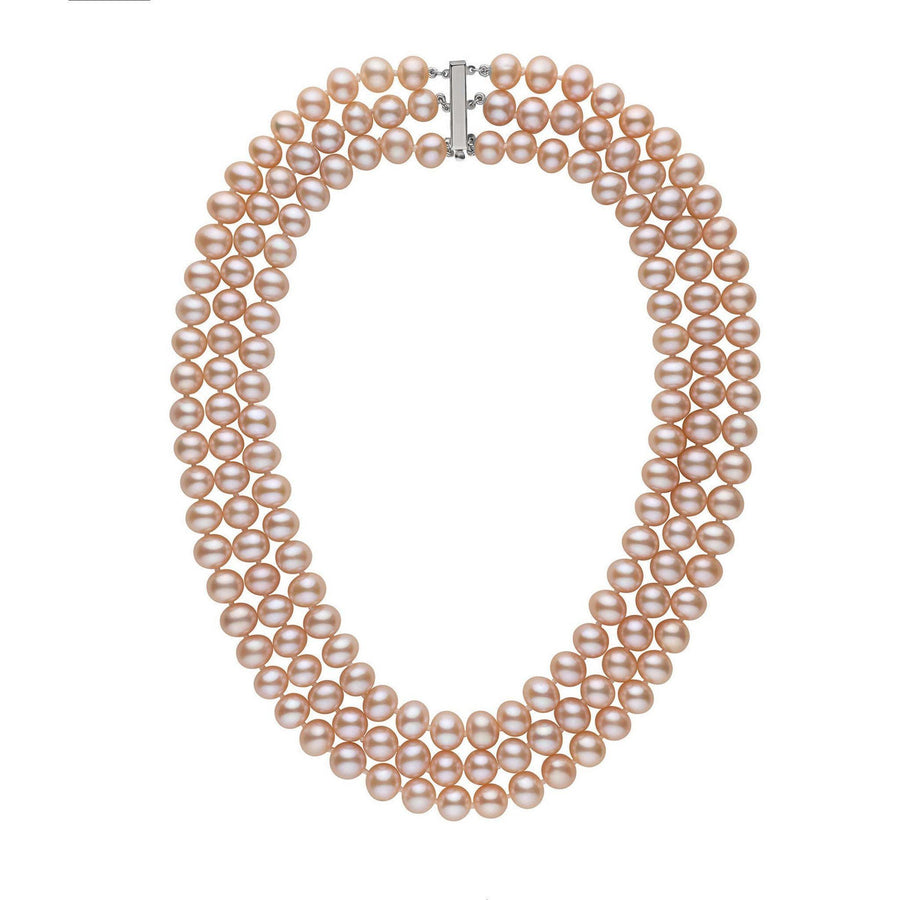 A triple strand of pink to peach freshwater pearl necklace with a solid 14 karat gold clasp.